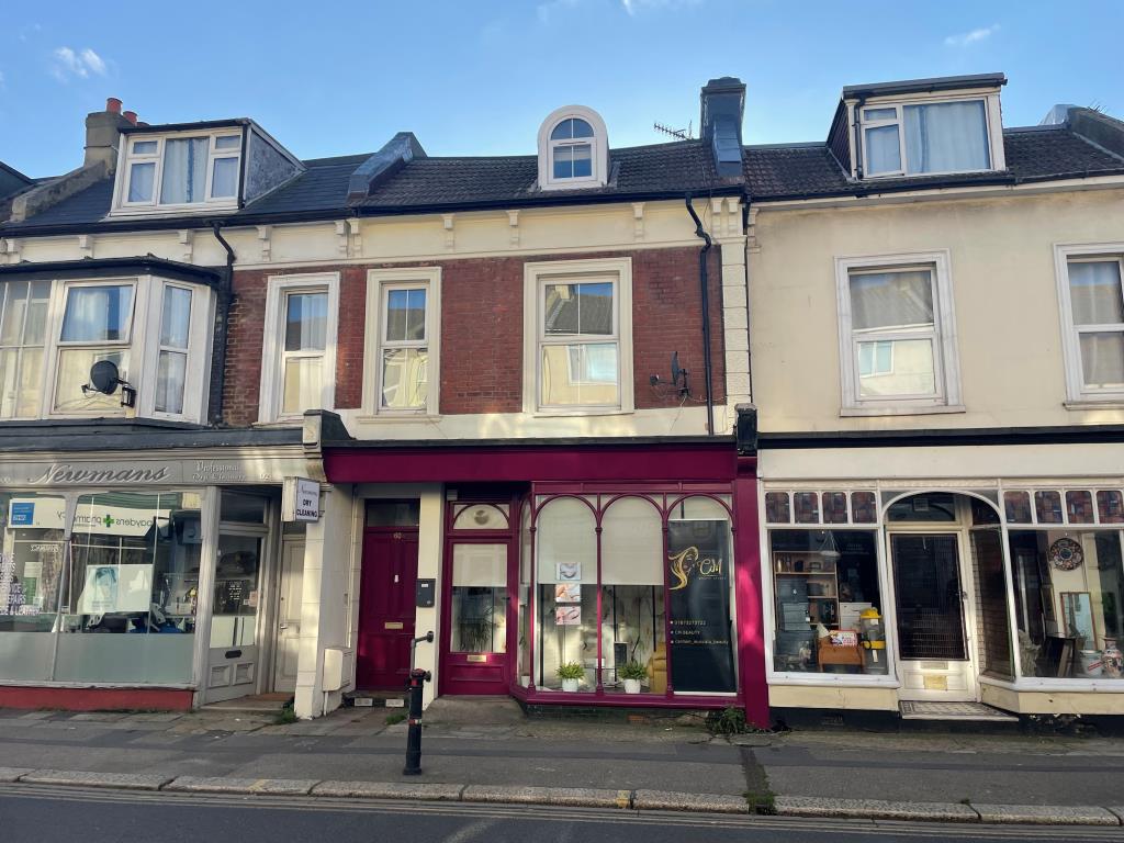 Lot: 77 - SHOP AND STUDIO FOR INVESTMENT WITH VACANT MAISONETTE - Mid-terrace block comprising shop and two flats with pink fascia